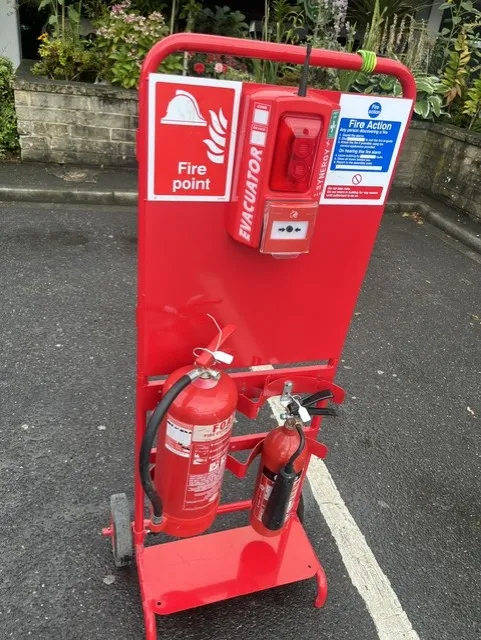 Radio linked fire trolley with a wireless call point, fire action signage and foam and CO2 extinguishers