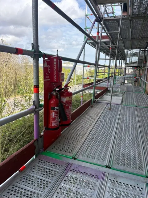 Radio linked fire point with foam and CO2 extinguishers on a scaffold walkway